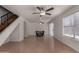 Spacious living area features wood floors, staircase and large window with blinds at 4644 W Havasupai Dr, Glendale, AZ 85308