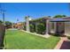 Green backyard features a brick fireplace, lawn and access to the pool at 4710 N 33Rd Pl, Phoenix, AZ 85018