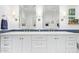 Bathroom featuring dual sinks, white cabinets, and elegant mirrors at 4710 N 33Rd Pl, Phoenix, AZ 85018