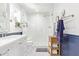 Bright bathroom with white subway tile shower, patterned floors, and beadboard accent at 4710 N 33Rd Pl, Phoenix, AZ 85018