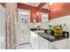 Red bathroom featuring a white vanity, black countertop and a door to the exterior at 4710 N 33Rd Pl, Phoenix, AZ 85018