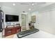 A bedroom with a flat-screen TV, guitars, and neutral decor at 4710 N 33Rd Pl, Phoenix, AZ 85018