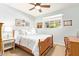 Bedroom featuring a wooden bed frame, ceiling fan and a bright window at 4710 N 33Rd Pl, Phoenix, AZ 85018