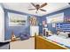 A blue bedroom with natural light, a ceiling fan, and an eclectic collection of decor at 4710 N 33Rd Pl, Phoenix, AZ 85018