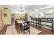 Charming dining area featuring a rustic wooden table, black chairs, and seamless flow to the kitchen and front entryway at 4710 N 33Rd Pl, Phoenix, AZ 85018