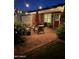 Evening view of a home's patio with comfortable seating, an umbrella, brickwork and string lights at 4710 N 33Rd Pl, Phoenix, AZ 85018