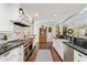 Well-appointed kitchen featuring white cabinetry, dark countertops, and stainless steel appliances in an open-concept layout at 4710 N 33Rd Pl, Phoenix, AZ 85018