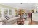Bright and open living room with hardwood floors, comfortable seating, and view into the adjoining dining area at 4710 N 33Rd Pl, Phoenix, AZ 85018
