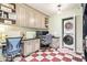 An office with built-in cabinets and two monitors. Laundry hookups are visible at 4710 N 33Rd Pl, Phoenix, AZ 85018