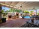A covered patio with a brick pizza oven and a view of the backyard pool at 4710 N 33Rd Pl, Phoenix, AZ 85018