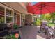Covered outdoor patio featuring a red umbrella, comfortable seating and brick paving at 4710 N 33Rd Pl, Phoenix, AZ 85018
