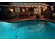 A view of an outdoor pool with a patio at night at 4710 N 33Rd Pl, Phoenix, AZ 85018