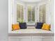 Close up of a window seat with neutral striped cushions and various colorful pillows at 4710 N 33Rd Pl, Phoenix, AZ 85018