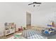 Spacious bedroom showcasing a variety of toys, a play area, and bright natural light at 5650 S Feliz --, Mesa, AZ 85212