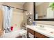 Cozy bathroom featuring a shower/tub combo, a vanity with a sink, and a mirrored medicine cabinet at 5654 W Vineyard Rd, Laveen, AZ 85339