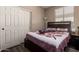 Comfortable bedroom with hardwood floors, closet space, and natural light from a window at 5654 W Vineyard Rd, Laveen, AZ 85339