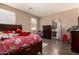 Spacious bedroom featuring hardwood floors, a bright window, and an en-suite bathroom at 5654 W Vineyard Rd, Laveen, AZ 85339