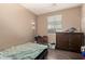Comfortable bedroom with hardwood floors, a ceiling fan, and ample natural light at 5654 W Vineyard Rd, Laveen, AZ 85339