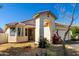 Inviting single-story home with desert landscaping, arched entryway, and charming curb appeal at 5654 W Vineyard Rd, Laveen, AZ 85339