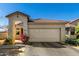Charming single-story home with a tile roof, two-car garage, and well-maintained landscaping at 5654 W Vineyard Rd, Laveen, AZ 85339