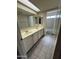 Bathroom featuring a double sink vanity, large mirrors, and ceramic tile floors at 6407 W Madras Ln, Glendale, AZ 85306