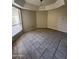 Empty room with neutral paint, tile flooring, and large window at 6407 W Madras Ln, Glendale, AZ 85306