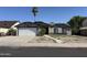 Charming single-story home featuring a two-car garage and a low maintenance front yard landscape at 6407 W Madras Ln, Glendale, AZ 85306