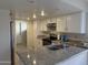 Bright kitchen featuring ample white cabinetry, granite countertops, and stainless steel appliances at 6407 W Madras Ln, Glendale, AZ 85306
