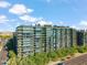 Stunning aerial view of a modern condominium building with lush landscaping and city views at 7180 E Kierland Blvd # 507, Scottsdale, AZ 85254