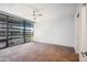 Clean, minimalist bedroom with carpet, a ceiling fan, and large windows with modern exterior views at 7180 E Kierland Blvd # 507, Scottsdale, AZ 85254