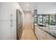 Sleek modern kitchen with stainless steel appliances, granite countertops, and a view to the outdoors at 7180 E Kierland Blvd # 507, Scottsdale, AZ 85254