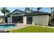 Back exterior with a sparkling pool and a large glass door that allows for an abundance of natural light at 7724 E Charter Oak Rd, Scottsdale, AZ 85260