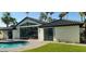 Back exterior with a sparkling pool and a large glass door that allows for an abundance of natural light at 7724 E Charter Oak Rd, Scottsdale, AZ 85260