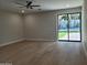Bright bedroom with hardwood floors and sliding glass doors that open to the backyard at 7724 E Charter Oak Rd, Scottsdale, AZ 85260