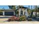 Charming one-story home featuring white brick, dark tile roof, and beautiful Bougainvillea landscaping at 7724 E Charter Oak Rd, Scottsdale, AZ 85260