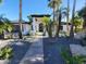 Charming one-story home featuring white brick, dark tile roof, and desert landscaping at 7724 E Charter Oak Rd, Scottsdale, AZ 85260
