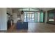 Open-concept kitchen with a large island, stainless steel appliances, and seamless flow to the outdoor pool area at 7724 E Charter Oak Rd, Scottsdale, AZ 85260
