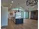 Open-concept kitchen with a large island, stainless steel appliances, and views of the outdoor living space and pool at 7724 E Charter Oak Rd, Scottsdale, AZ 85260