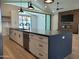 Open kitchen with a large island, black countertops and white cabinetry, connecting to the living area at 7724 E Charter Oak Rd, Scottsdale, AZ 85260