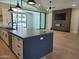 Close up of the kitchen island featuring a sink, black faucet, and hardwood flooring throughout at 7724 E Charter Oak Rd, Scottsdale, AZ 85260