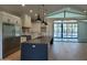 Open-concept kitchen with a large island, stainless steel appliances, and access to an outdoor pool for seamless entertaining at 7724 E Charter Oak Rd, Scottsdale, AZ 85260