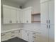 Modern kitchen featuring white cabinets, marble countertops, and open shelving at 7724 E Charter Oak Rd, Scottsdale, AZ 85260