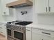 Modern kitchen featuring stainless steel appliances, white cabinets, and a pot filler, offering a chef-inspired culinary space at 7724 E Charter Oak Rd, Scottsdale, AZ 85260