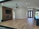 Spacious living room featuring hardwood flooring, media wall, and doors to the exterior at 7724 E Charter Oak Rd, Scottsdale, AZ 85260