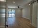 Expansive living room with hardwood floors, recessed lighting, and sliding glass doors leading to the outdoor space at 7724 E Charter Oak Rd, Scottsdale, AZ 85260