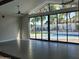 Bright living room featuring tile floors, large glass doors and windows that lead to a sparkling pool at 7724 E Charter Oak Rd, Scottsdale, AZ 85260