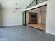 Bright living room with hardwood floors that flow into another room with a fireplace and entertainment center at 7724 E Charter Oak Rd, Scottsdale, AZ 85260