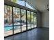 Bright living room featuring tile floors, large glass doors and windows that lead to a sparkling pool at 7724 E Charter Oak Rd, Scottsdale, AZ 85260