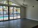 Bright living room featuring tile floors, large glass doors and windows that lead to a sparkling pool at 7724 E Charter Oak Rd, Scottsdale, AZ 85260