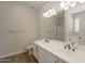 Bathroom featuring double sinks, a large mirror, and modern lighting fixtures at 9074 W Runion Dr, Peoria, AZ 85382